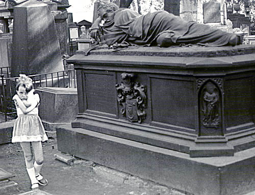 picture of girl in front of grave